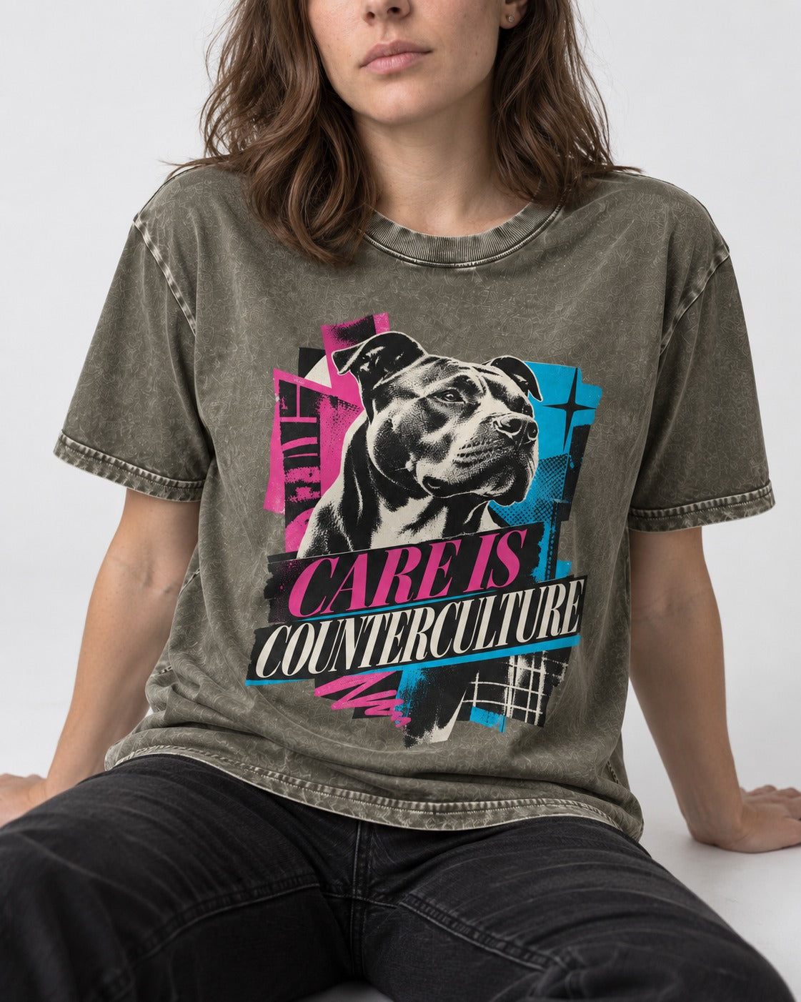 Pitbull Care Is Counterculture Neon Collage Portrait Graphic Washed Tee in Army Green, worn by a seated model