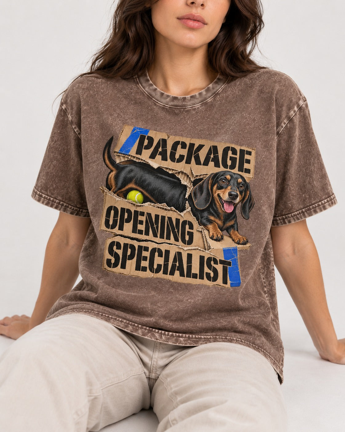 Dachshund Package Opening Specialist Washed Tee in Coffee, worn by a seated model