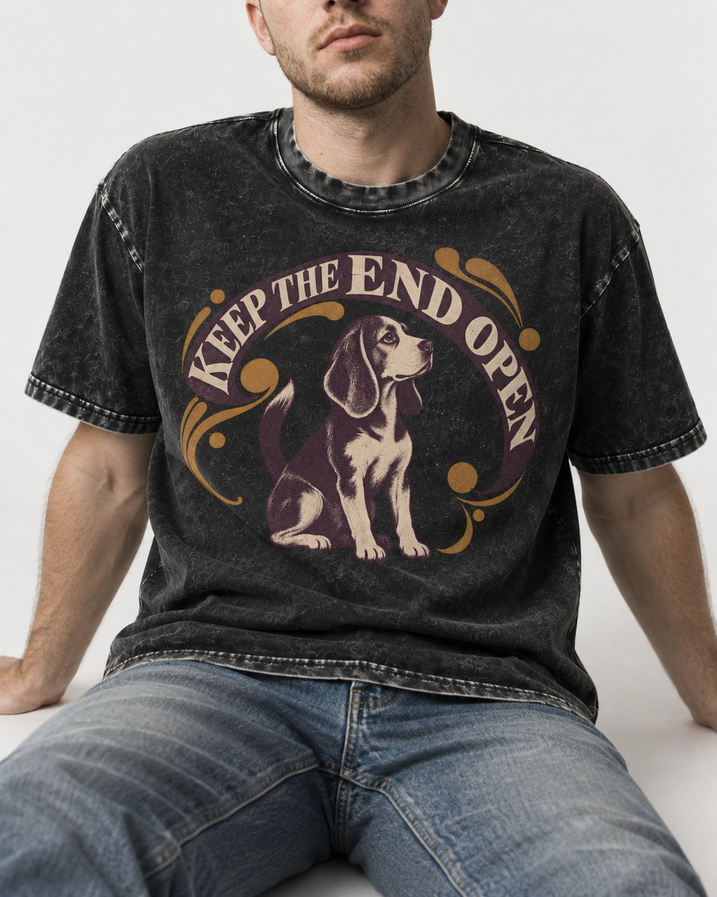 Beagle Keep The End Open Ornamental Graphic Washed Tee in Black, worn by a seated model