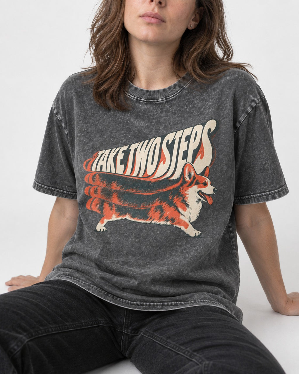 Corgi Take Two Steps Motion Trail Graphic Washed Tee in Gray, worn by a seated model