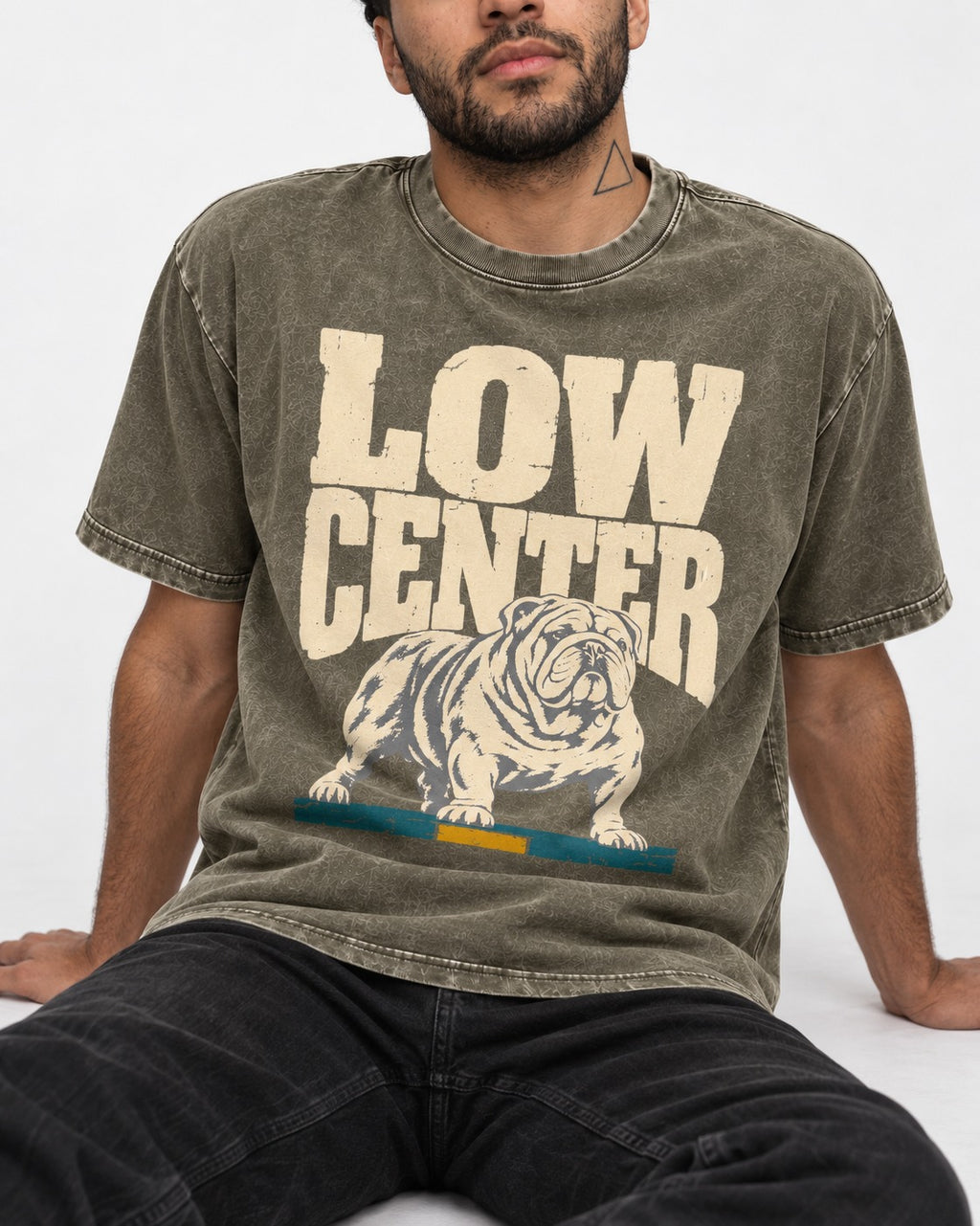 English Bulldog Low Center Stance Graphic Washed Tee in Army Green, worn by a seated model
