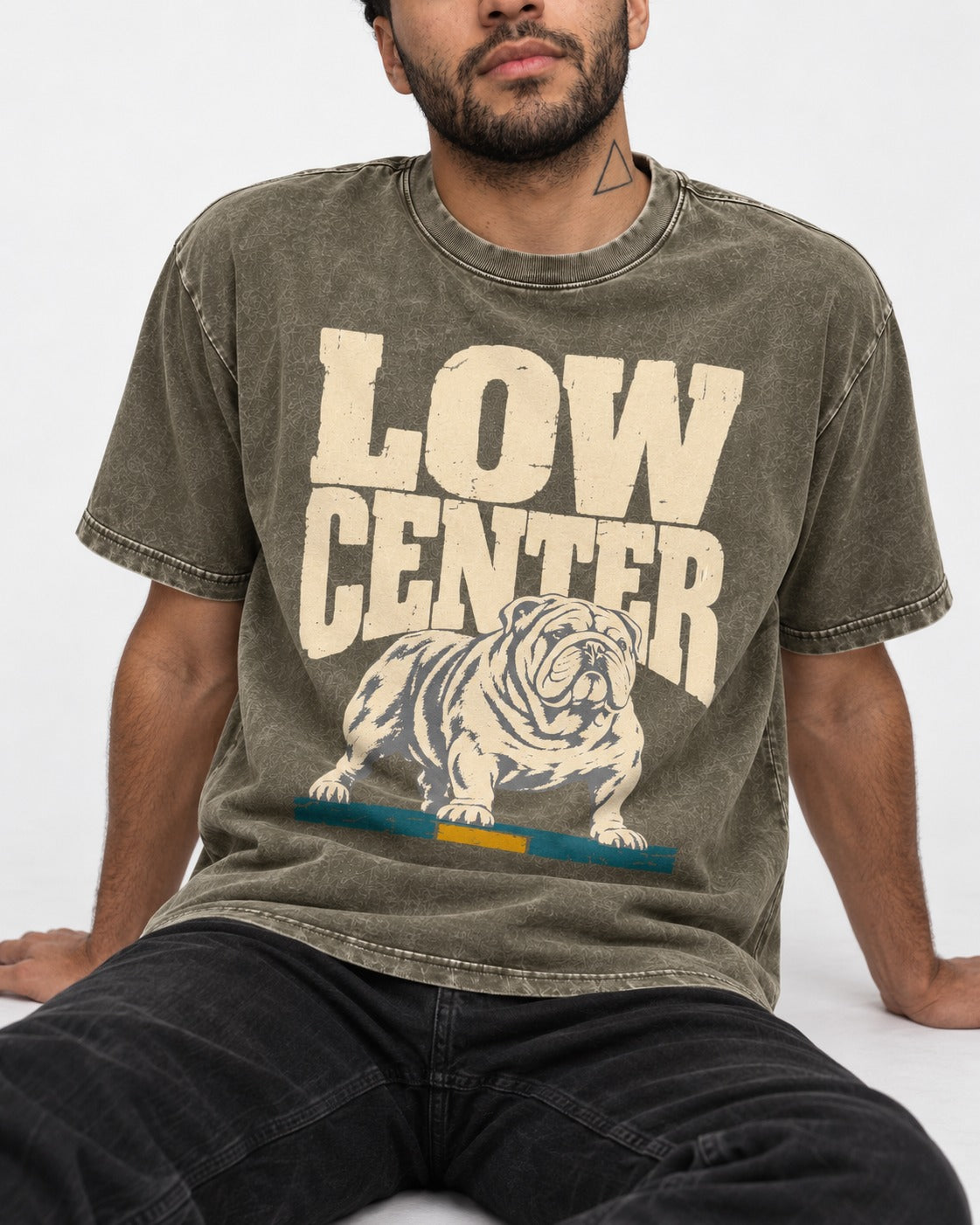 English Bulldog Low Center Stance Graphic Washed Tee in Army Green, worn by a seated model