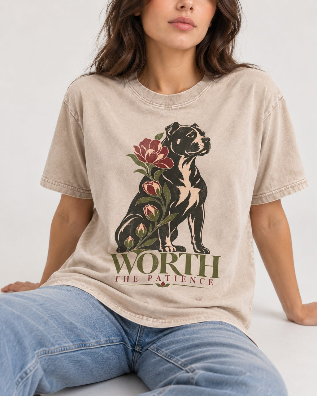 Pitbull Worth the Patience Washed Tee in Apricot, worn by a seated model