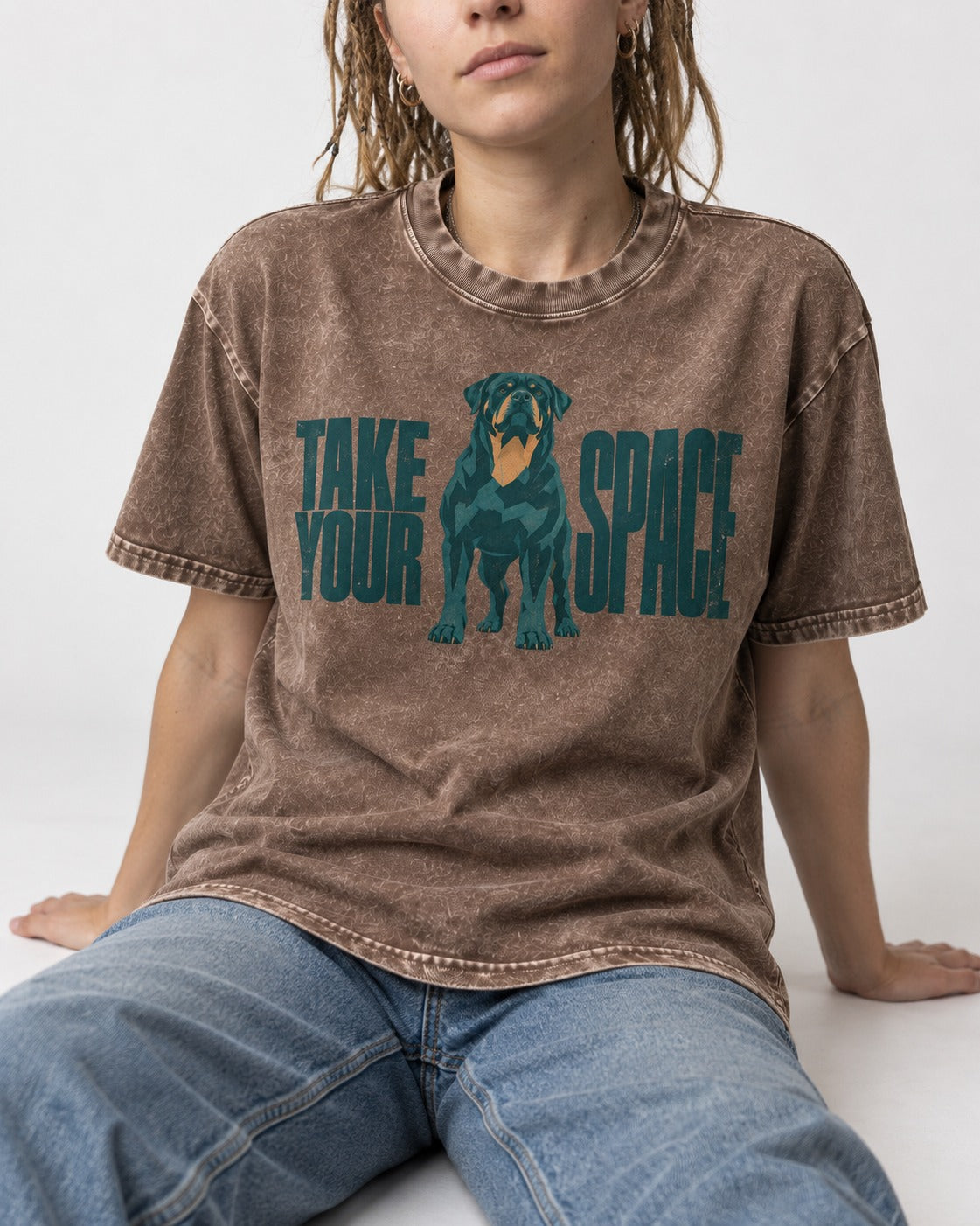 Rottweiler Take Your Space Washed Tee in Coffee, worn by a seated model