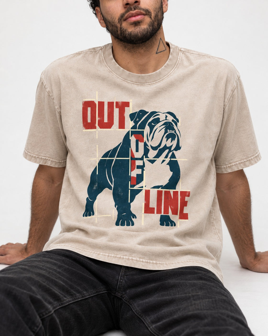 English Bulldog Out of Line Washed Tee in Apricot, worn by a seated model