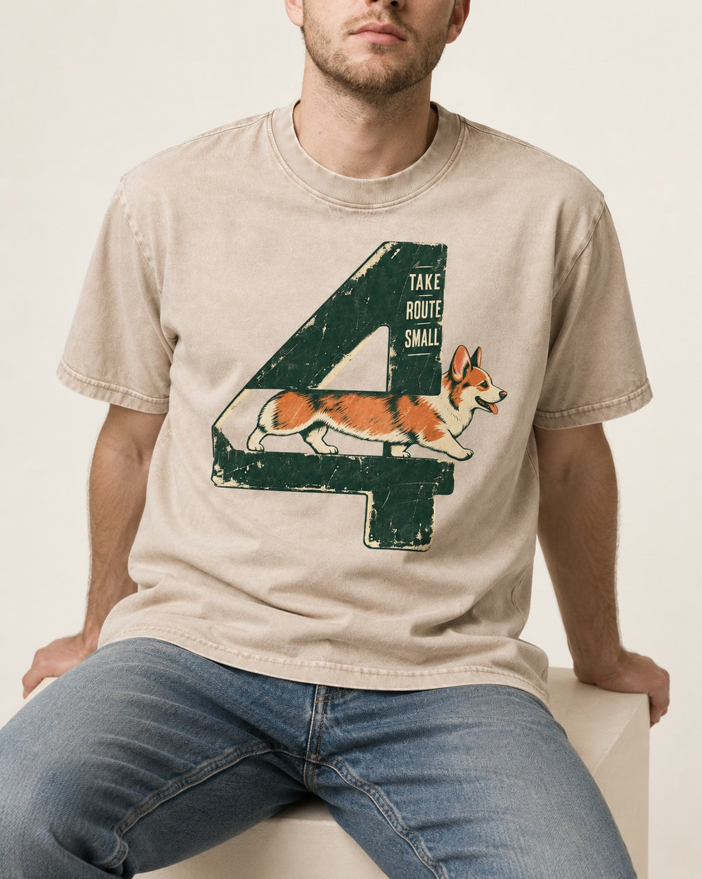 Take Route Small Corgi Washed Tee in Apricot, worn by a seated model