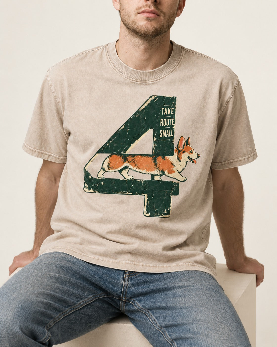 Take Route Small Corgi Washed Tee in Apricot, worn by a seated model