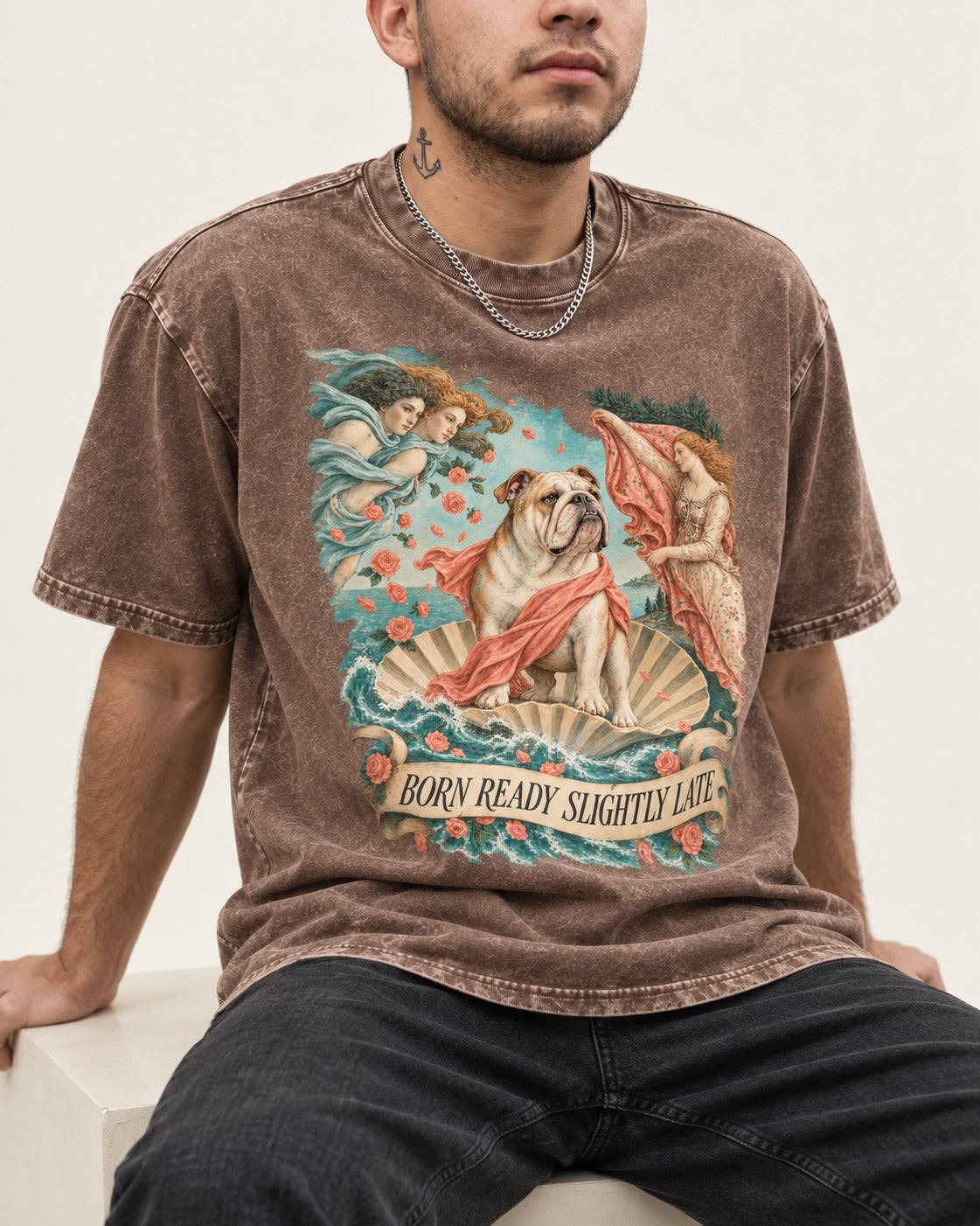 Born Ready Slightly Late English Bulldog Washed Tee in Coffee, worn by a seated model