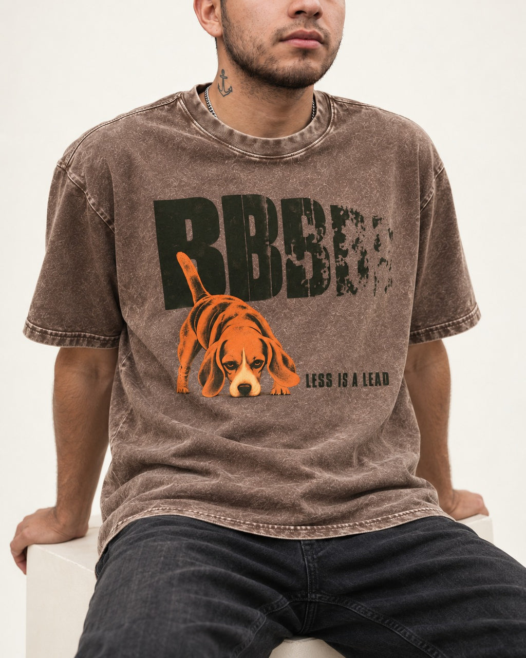 Less Is a Lead Beagle Washed Tee in Coffee, worn by a seated model