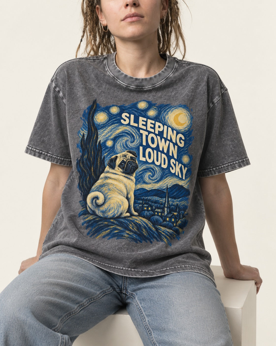 Pug Sleeping Town Loud Sky Starry Night Graphic Washed Tee in Gray, worn by a seated model