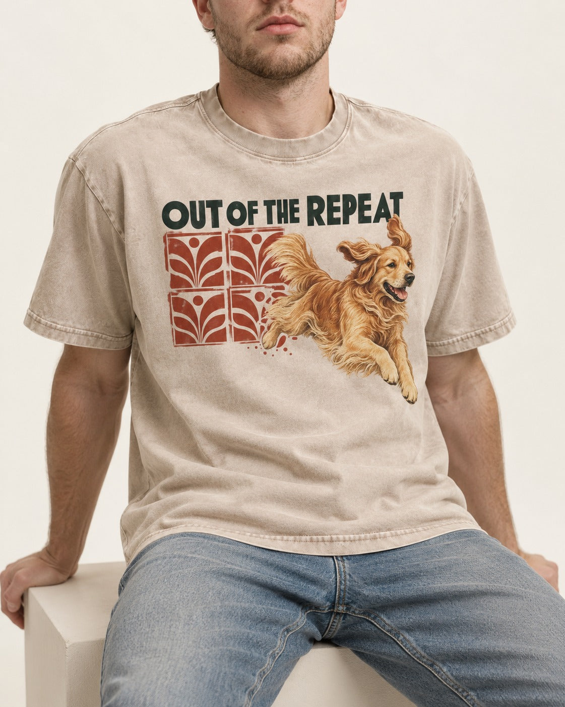 Golden Retriever Out of the Repeat Washed Tee in Apricot, worn by a seated model