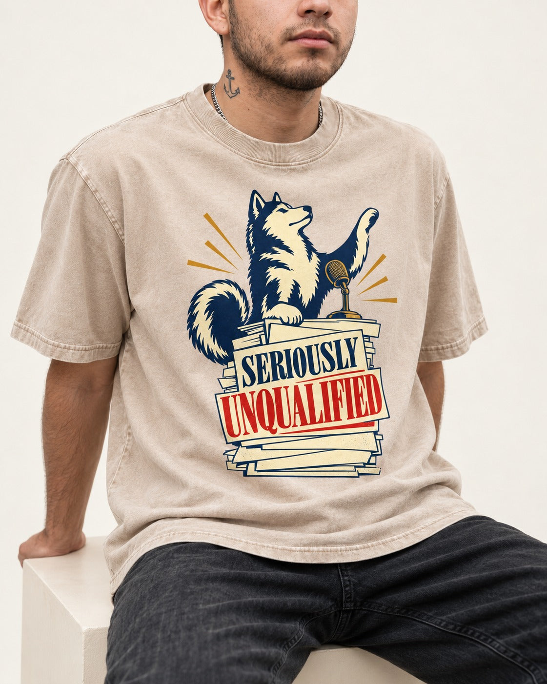 Seriously Unqualified Husky Washed Tee in Apricot, worn by a seated model