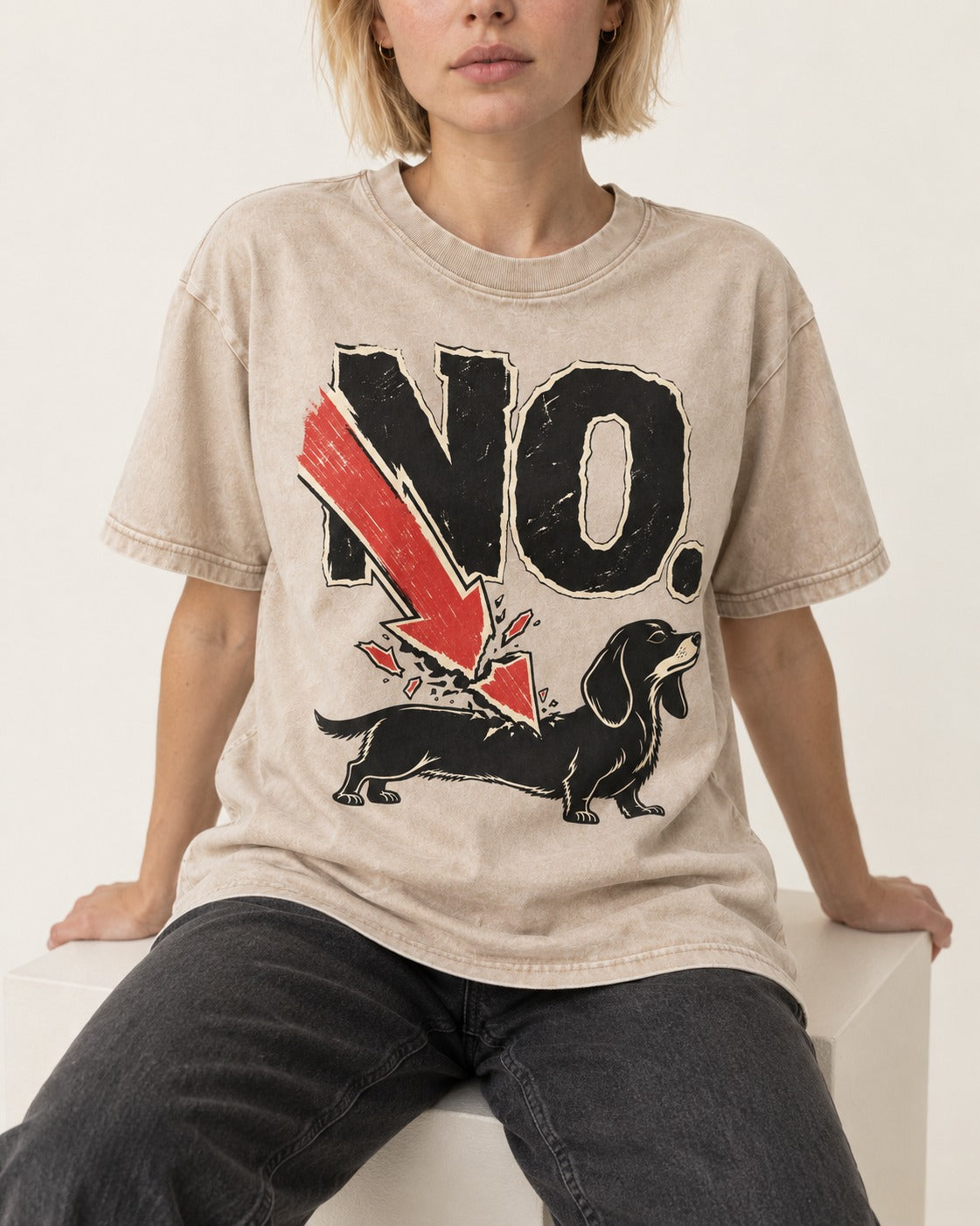 Dachshund Says No Washed Tee in Apricot, worn by a seated model