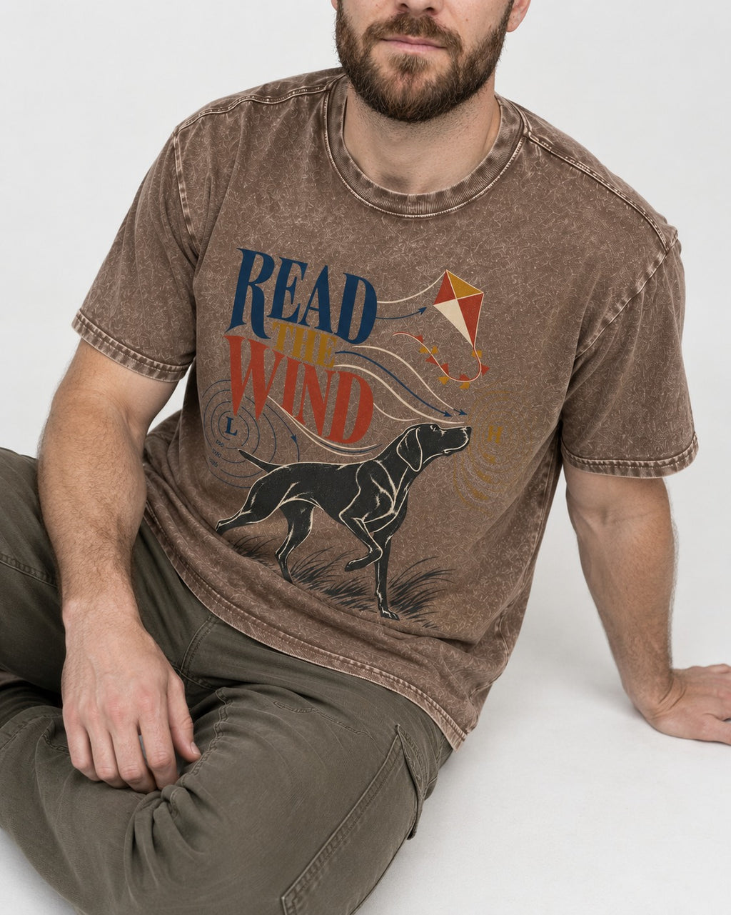 Read the Wind German Shorthaired Pointer Washed Tee in Coffee, worn by a seated model
