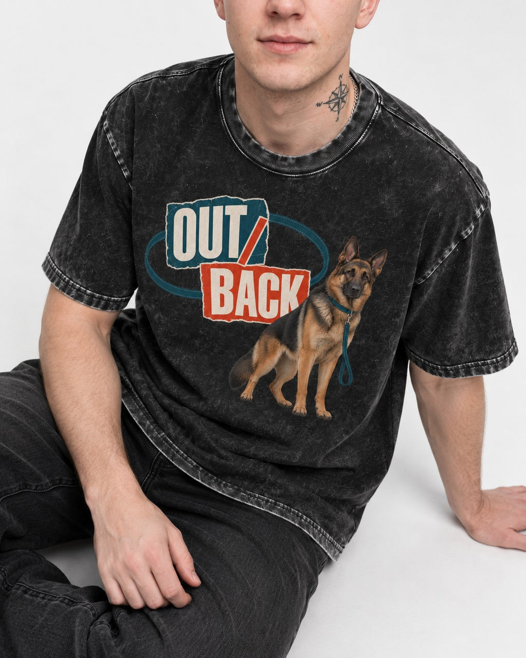 Out Back Leash German Shepherd Dog Graphic Washed Tee in Black, worn by a seated model