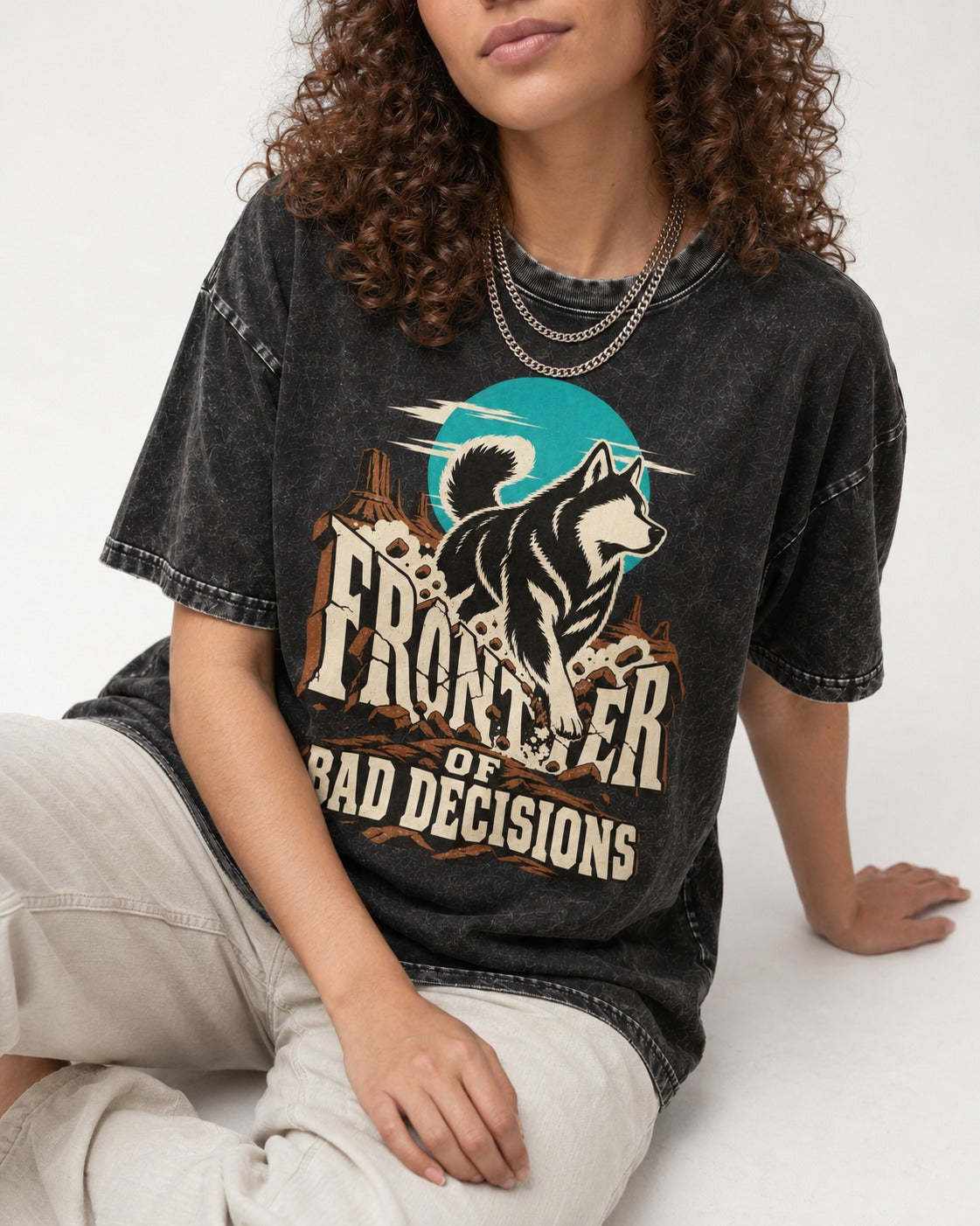 Husky Frontier of Bad Decisions Desert Graphic Washed Tee in Black, worn by a seated model