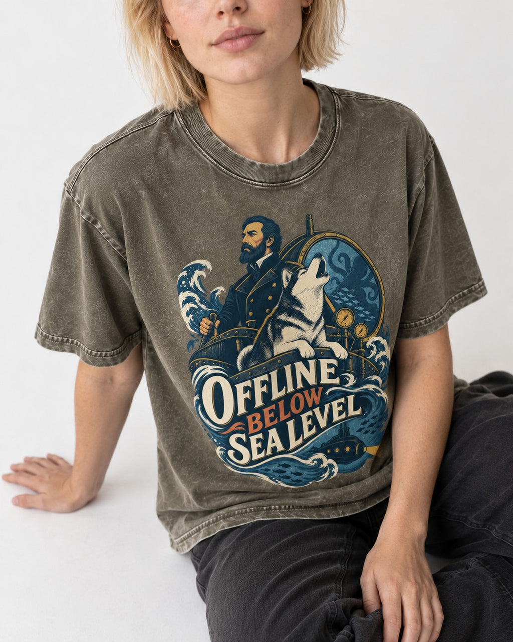 Husky Offline Below Sea Level Nautical Submarine Graphic Washed Tee in Army Green, worn by a seated model