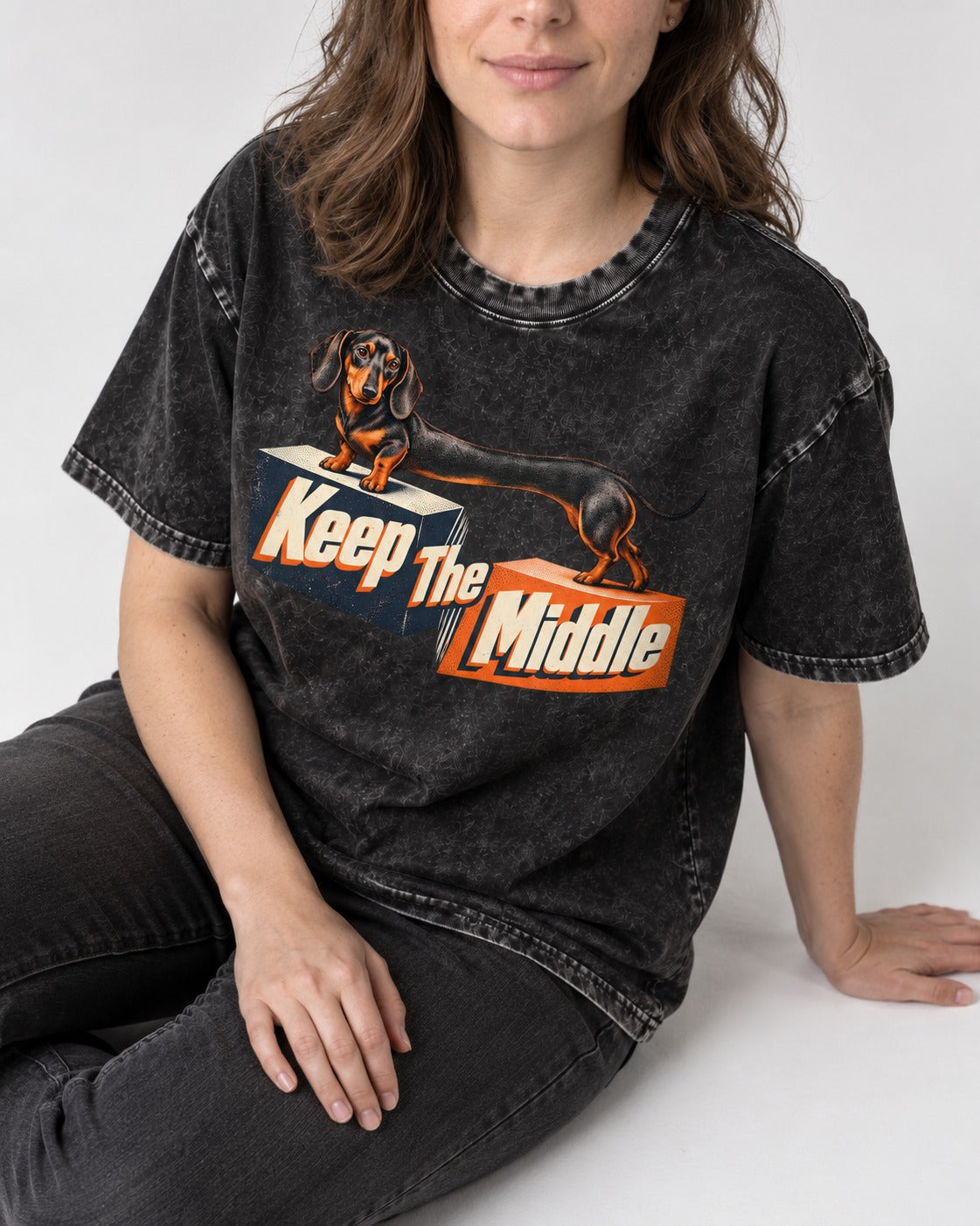 Dachshund Keep The Middle Block Bridge Graphic Washed Tee in Black, worn by a seated model