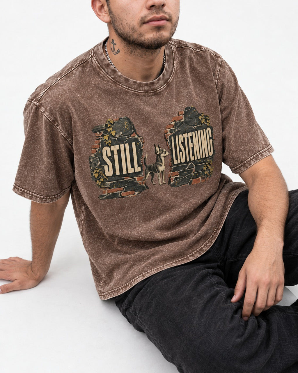 Chihuahua Still Listening Washed Tee in Coffee, worn by a seated model