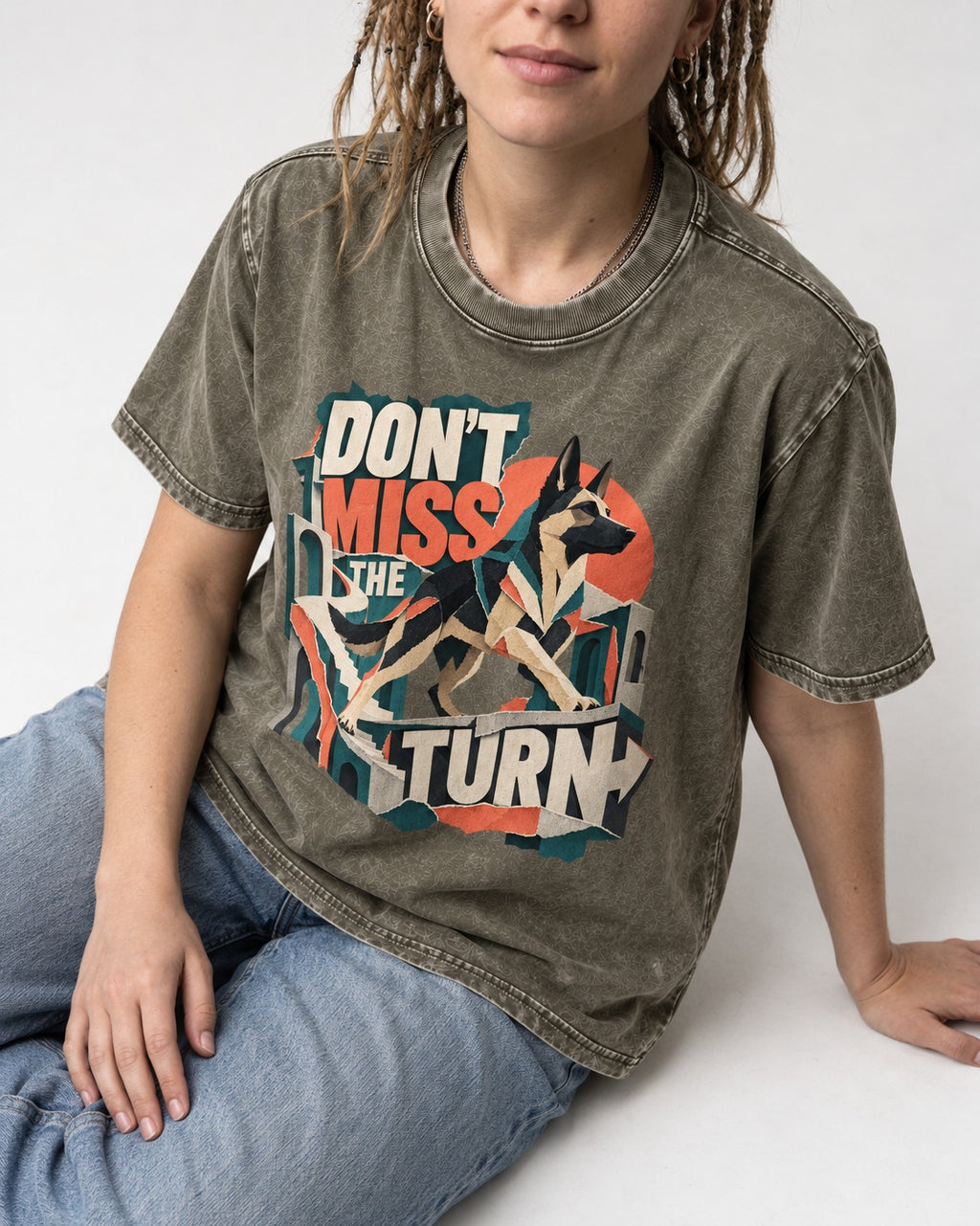 Dont Miss The Turn Escher Staircase German Shepherd Dog Graphic Washed Tee in Army Green, worn by a seated model