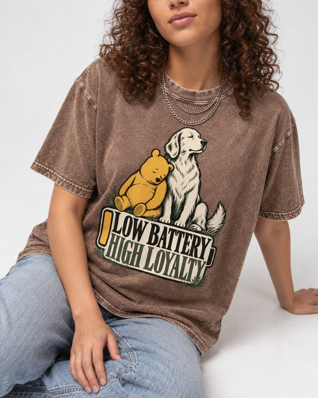 Golden Retriever Low Battery High Loyalty Washed Tee in Coffee, worn by a seated model