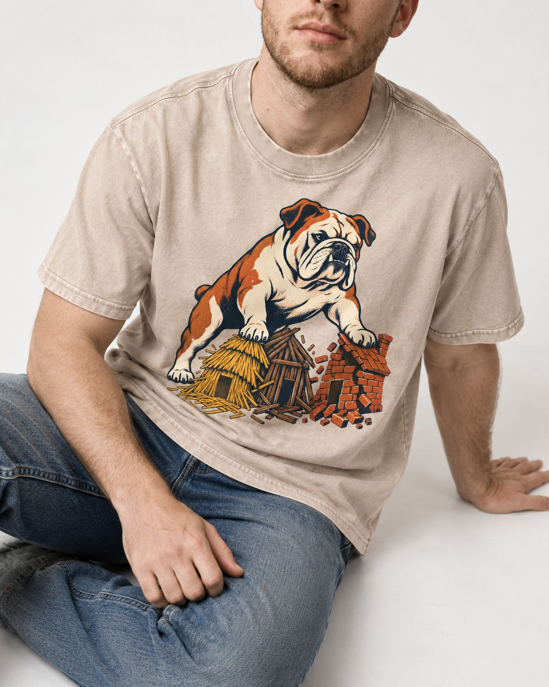 English Bulldog Huff and Puff Washed Tee in Apricot, worn by a seated model