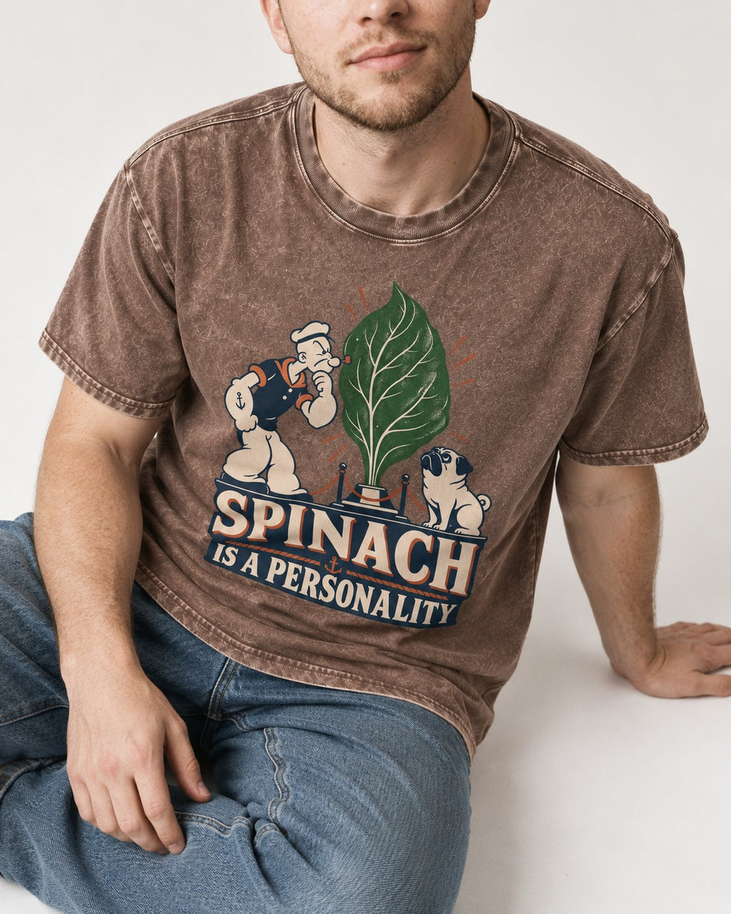 Pug Spinach Is a Personality Leaf Exhibit Graphic Washed Tee in Coffee, worn by a seated model