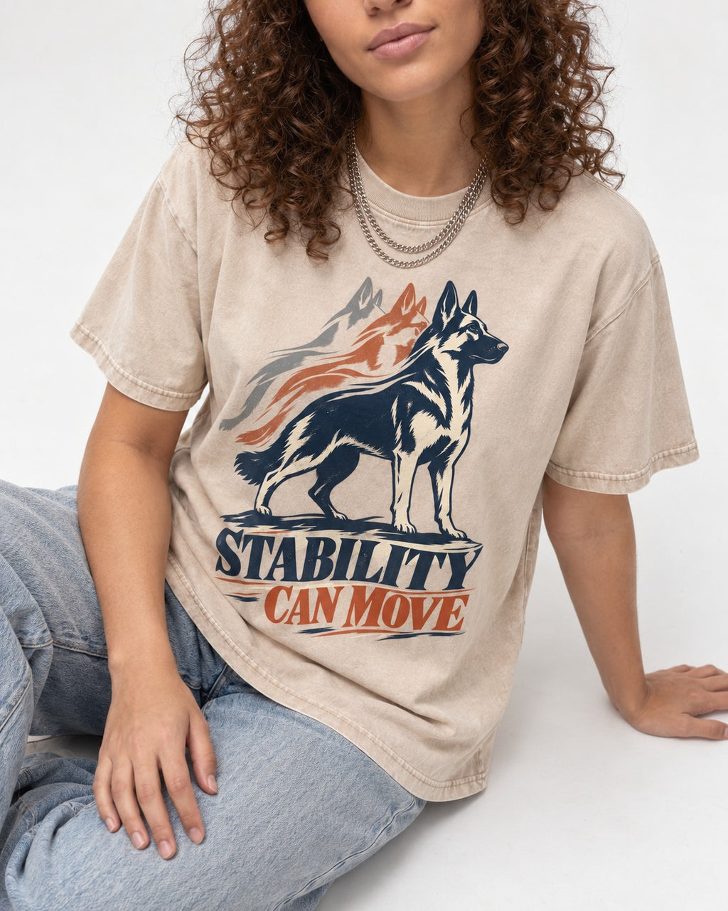 Stability Can Move German Shepherd Dog Washed Tee in Apricot, worn by a seated model