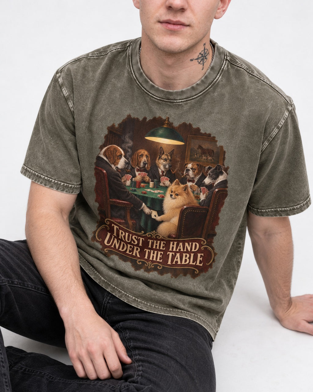 Pomeranian Trust the Hand Under the Table Poker Dogs Graphic Washed Tee in Army Green, worn by a seated model