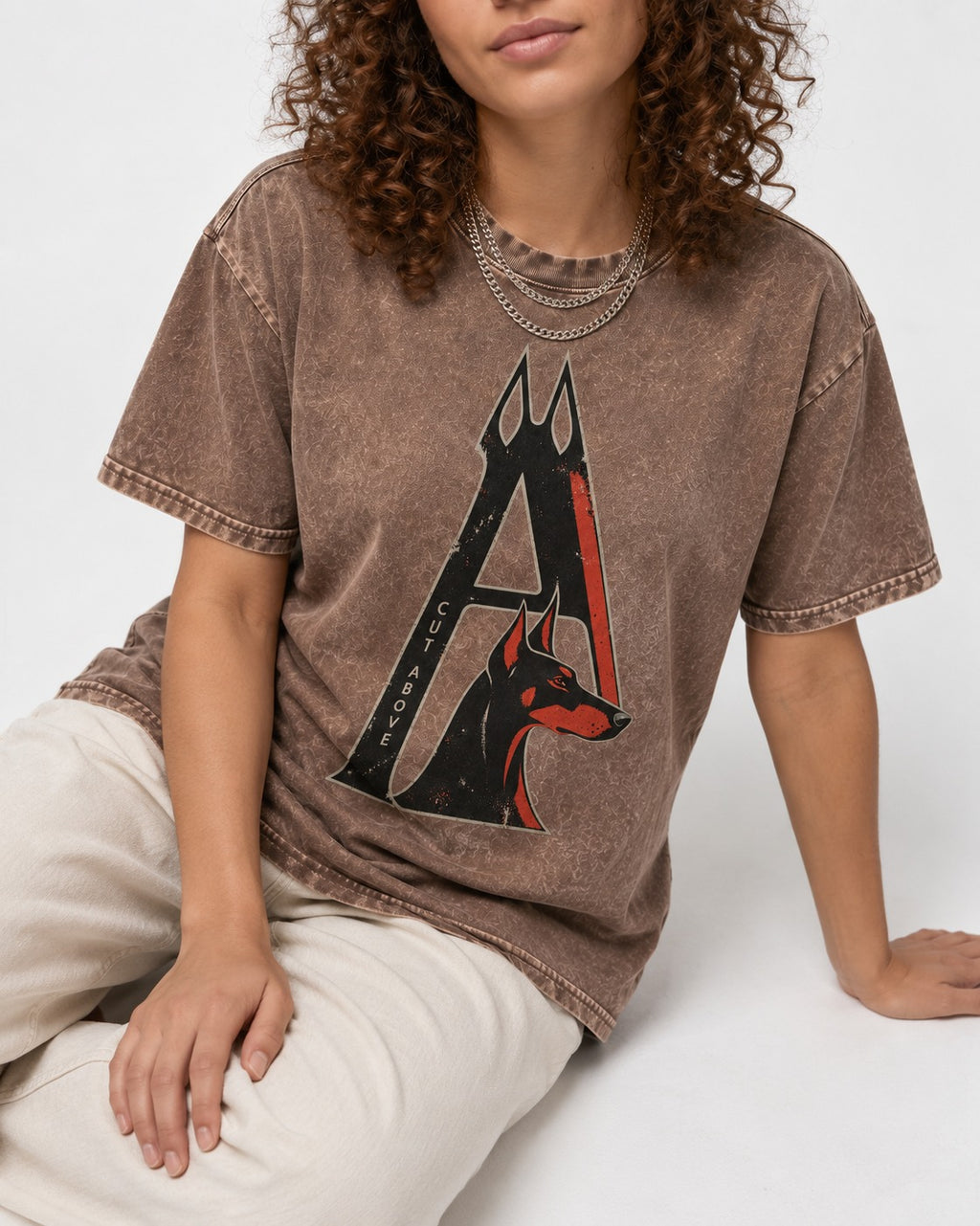 Doberman A Cut Above Washed Tee in Coffee, worn by a seated model