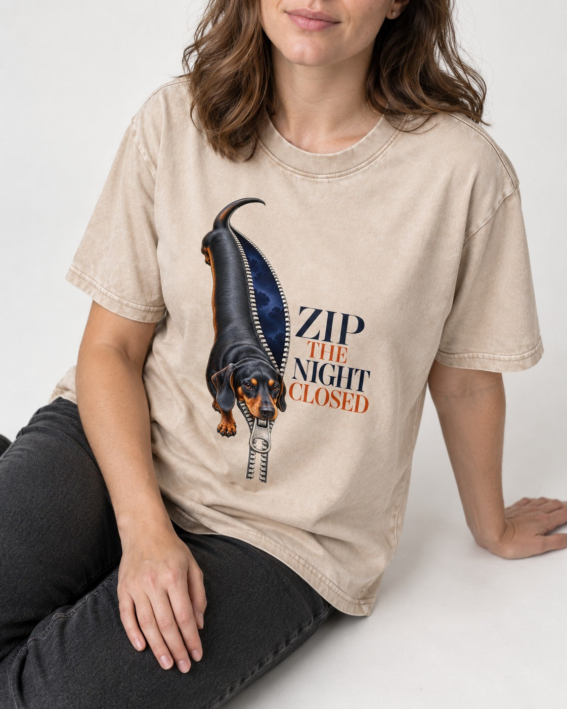 Zip the Night Closed Dachshund Washed Tee in Apricot, worn by a seated model