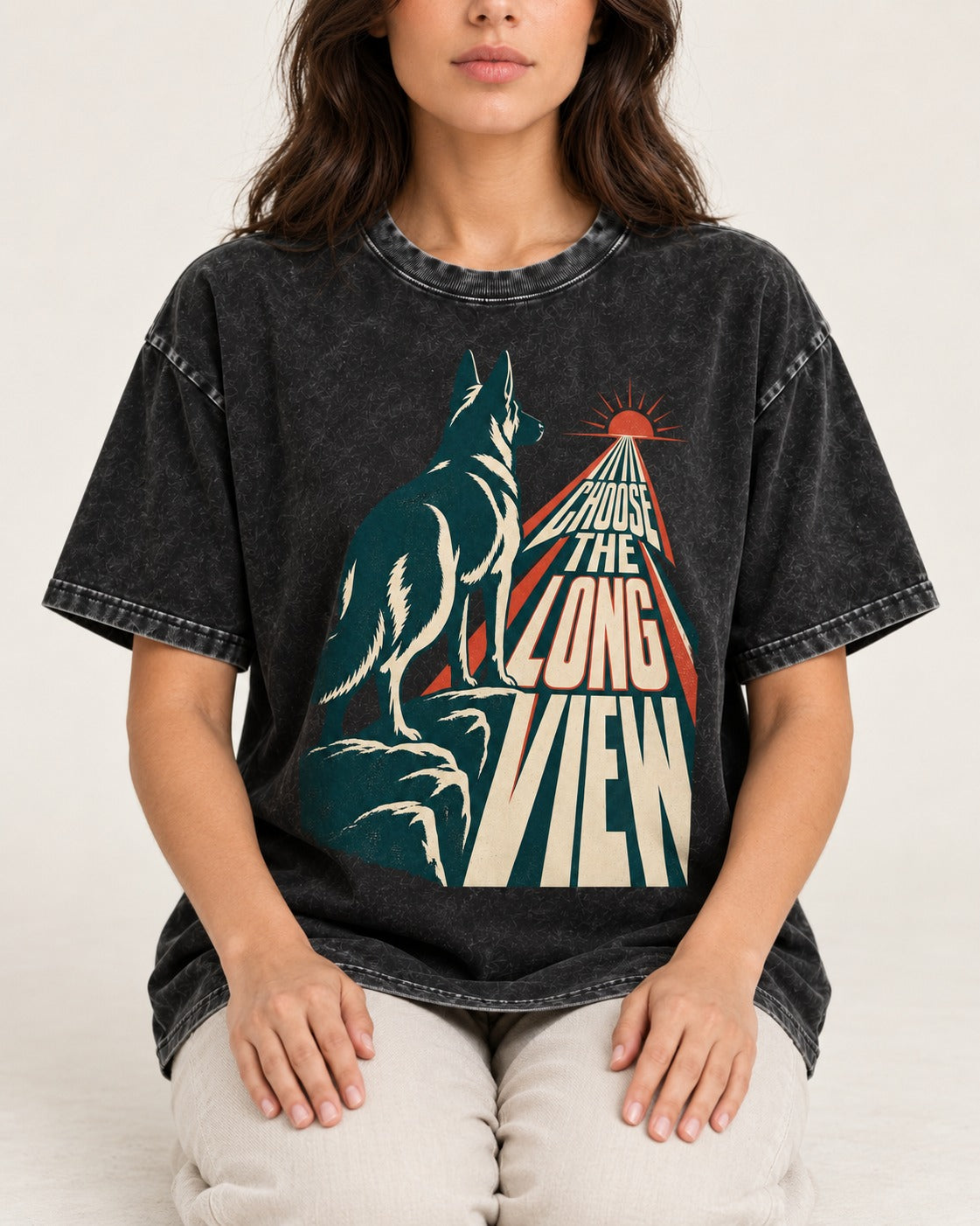 Choose the Long View Sunrise German Shepherd Dog Graphic Washed Tee in Black, worn by a seated model