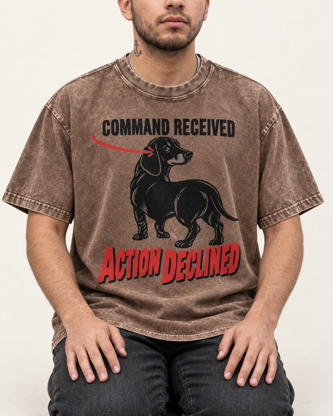Dachshund Action Declined Washed Tee in Coffee, worn by a seated model