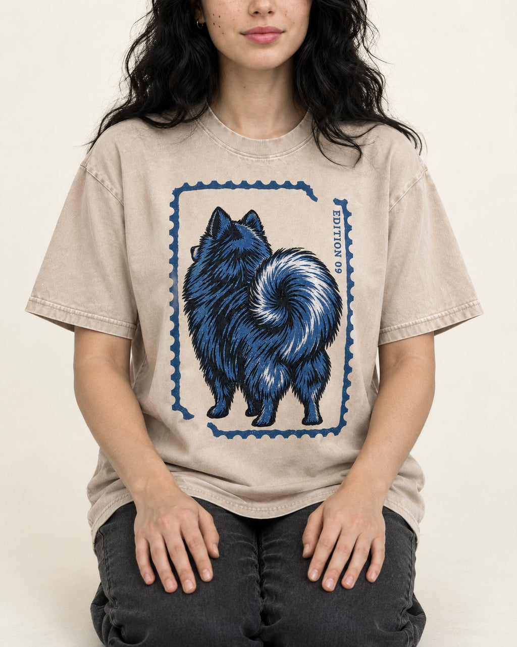 Pomeranian Pride Washed Tee in Apricot, worn by a seated model