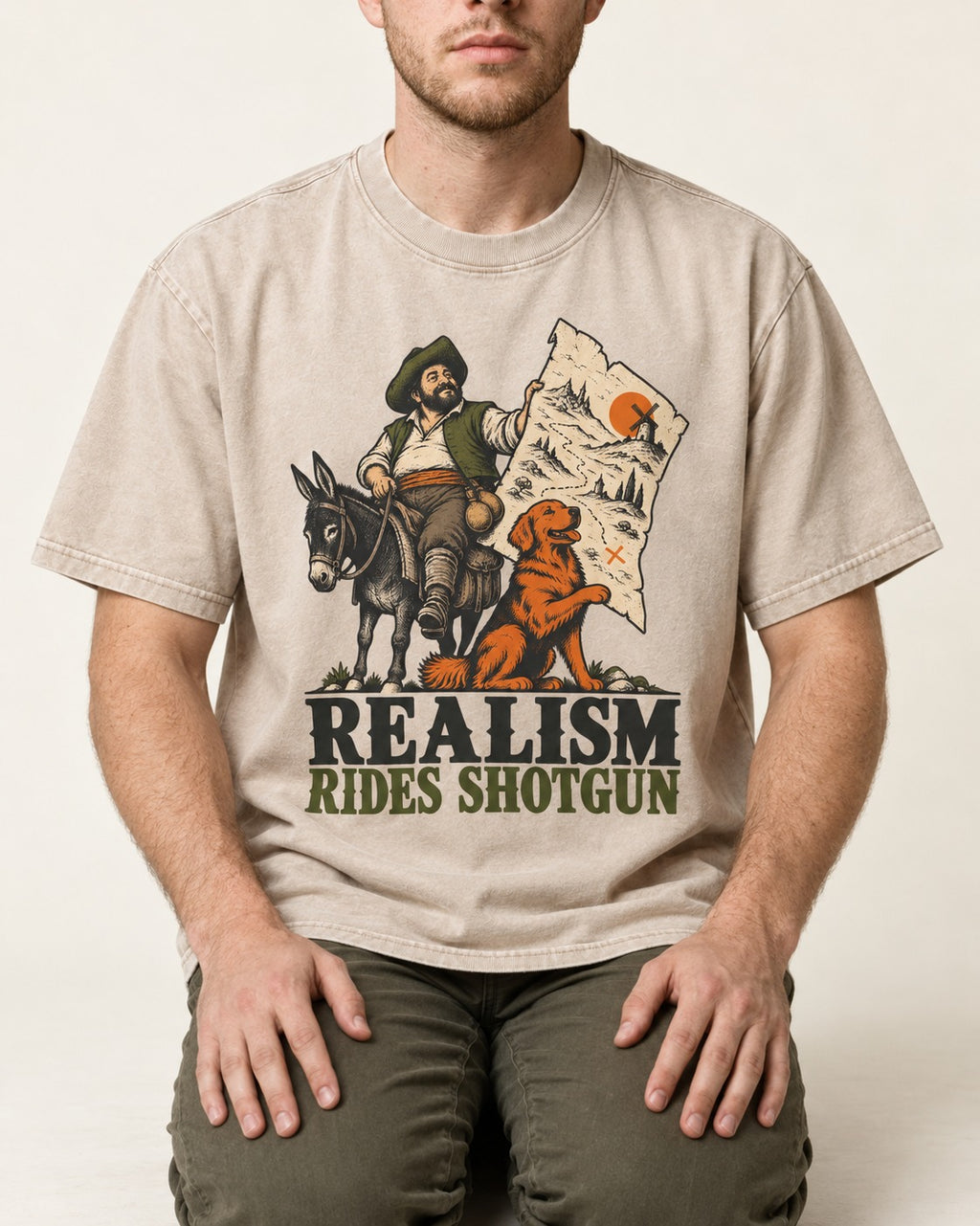 Realism Rides Shotgun with Golden Retriever Washed Tee in Apricot, worn by a seated model