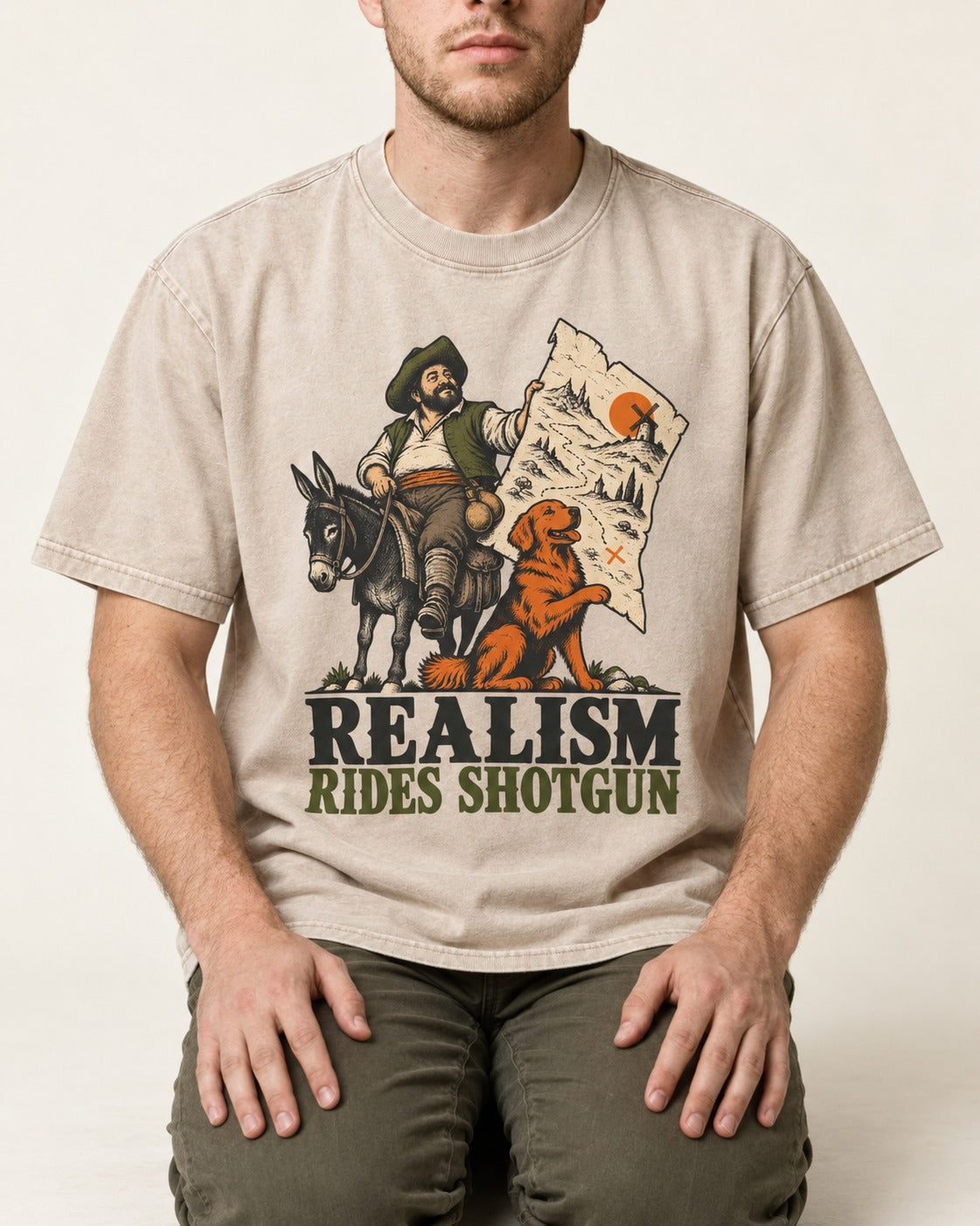Realism Rides Shotgun with Golden Retriever Washed Tee in Apricot, worn by a seated model