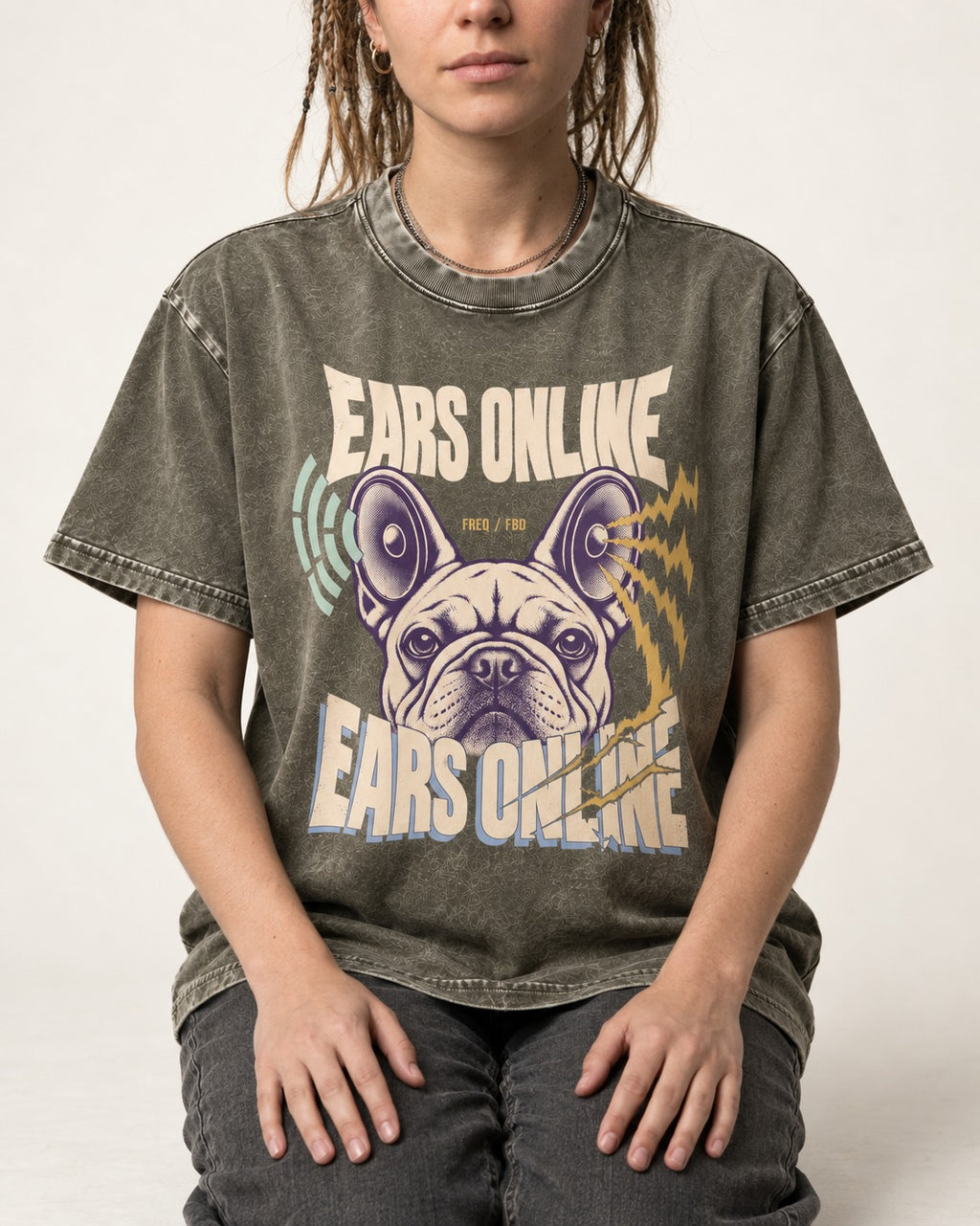 Frenchie Ears Online Audio Signal Graphic Washed Tee in Army Green, worn by a seated model