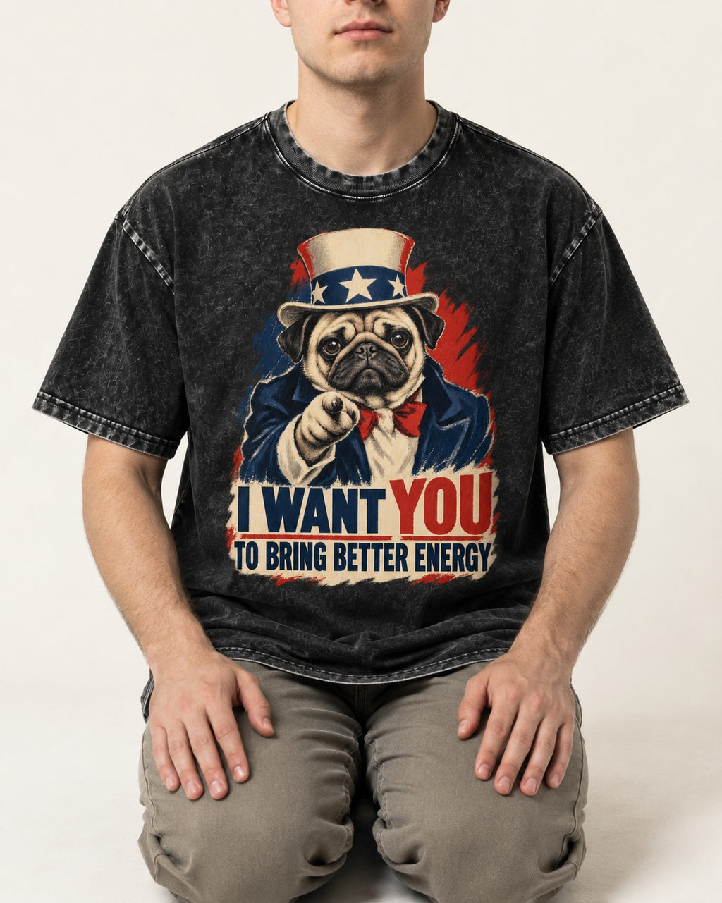 Pug I Want You to Bring Better Energy Uncle Sam Graphic Washed Tee in Black, worn by a seated model