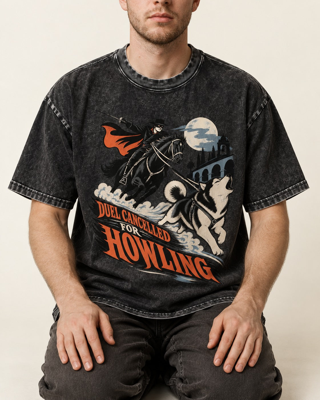 Husky Duel Cancelled for Howling Masked Rider Graphic Washed Tee in Black, worn by a seated model