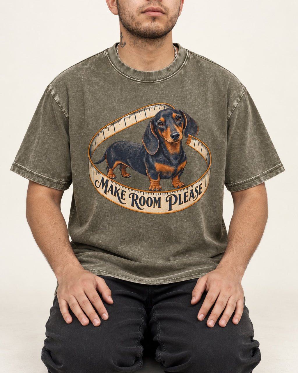 Dachshund Make Room Please Measuring Tape Graphic Washed Tee in Army Green, worn by a seated model