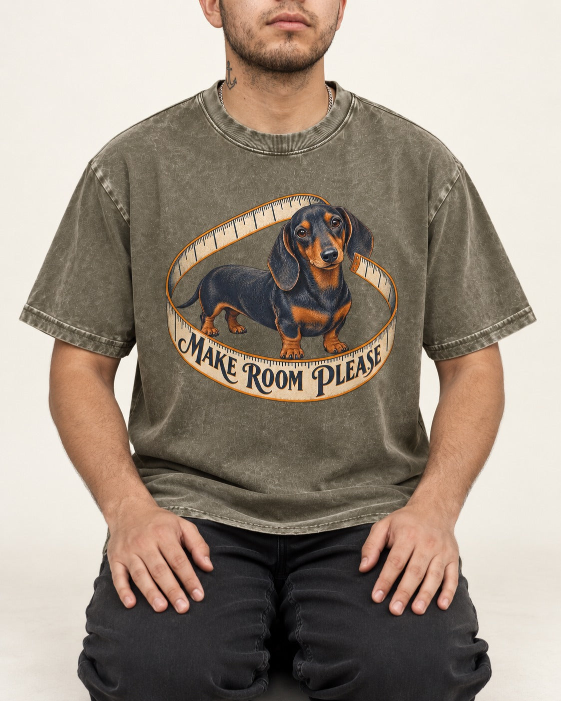 Dachshund Make Room Please Measuring Tape Graphic Washed Tee in Army Green, worn by a seated model
