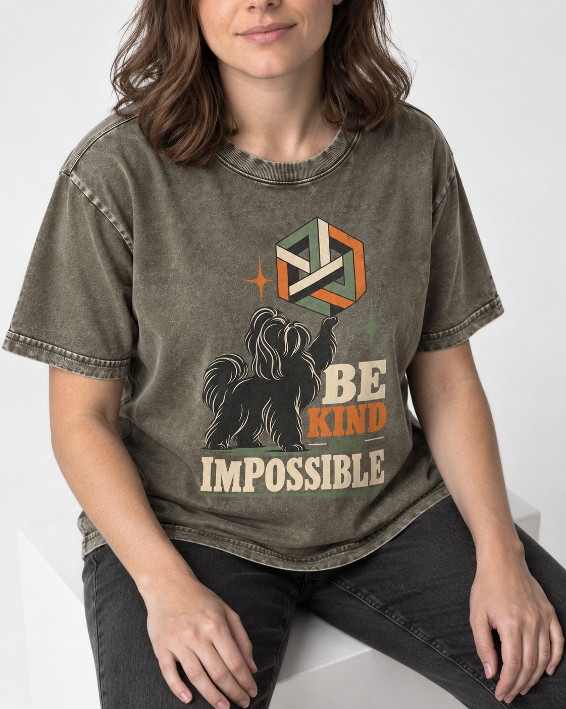 Shih Tzu Be Kind and Impossible Geometric Cube Graphic Washed Tee in Army Green, worn by a seated model