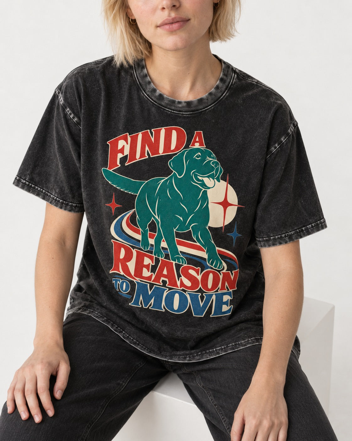 Labrador Retriever Find a Reason to Move Retro Dog Graphic Washed Tee in Black, worn by a seated model