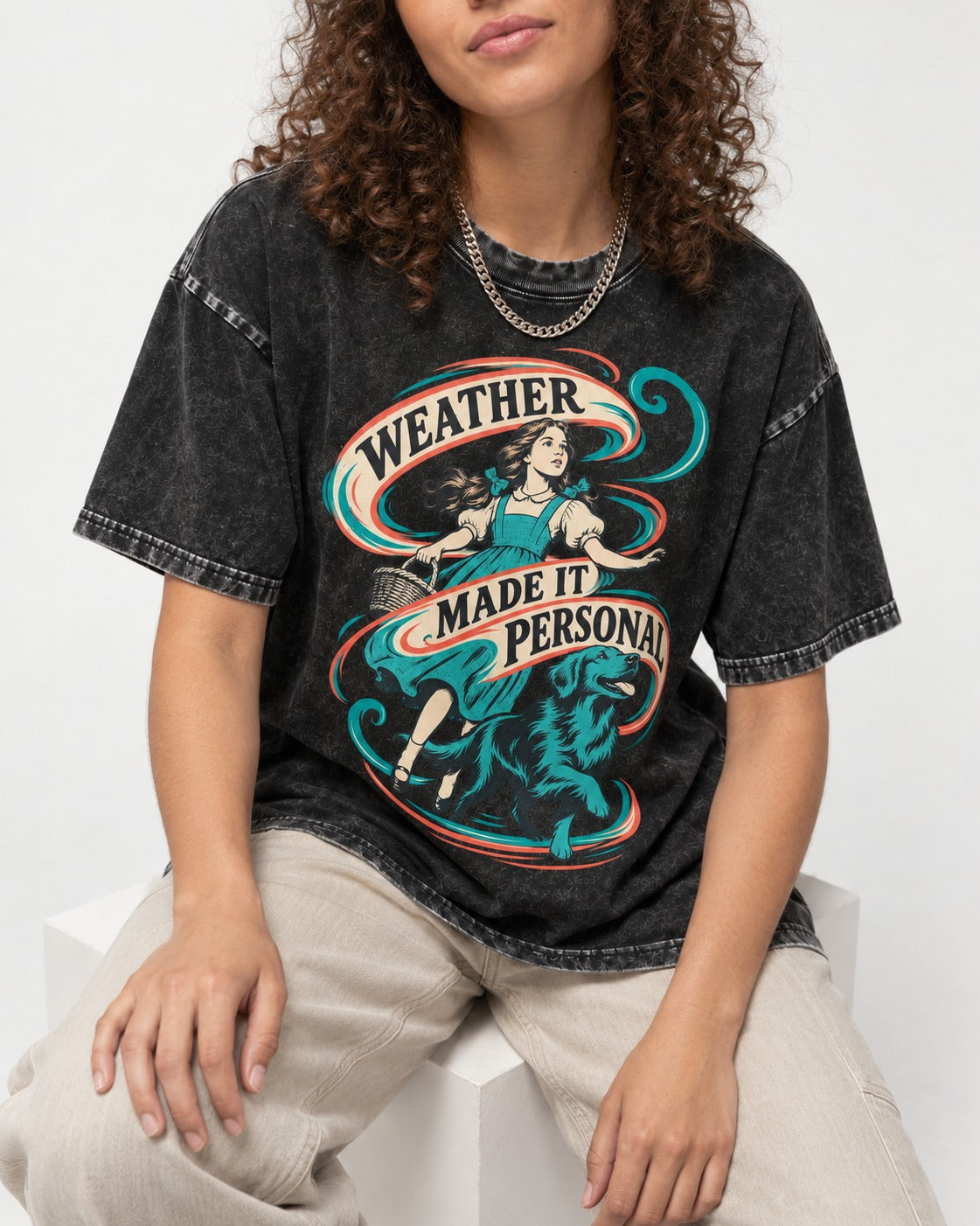 Golden Retriever Weather Made It Personal Woman Graphic Washed Tee in Black, worn by a seated model