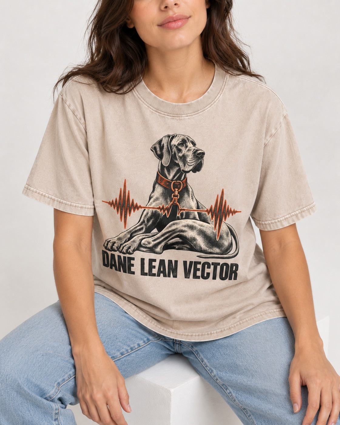 Great Dane Lean Washed Tee in Apricot, worn by a seated model
