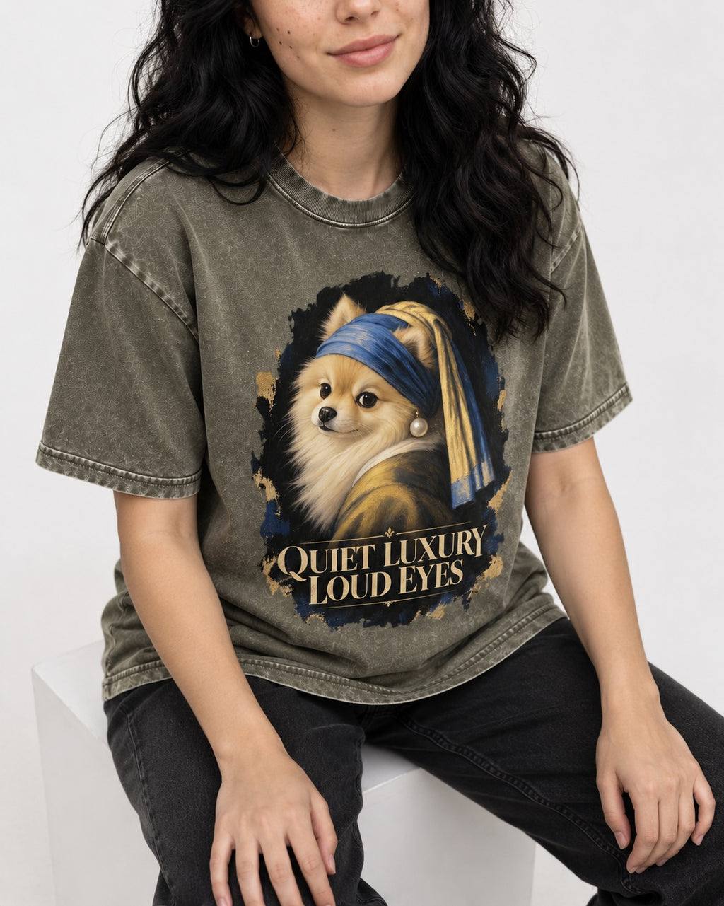 Pomeranian Quiet Luxury Loud Eyes Pearl Portrait Graphic Washed Tee in Army Green, worn by a seated model