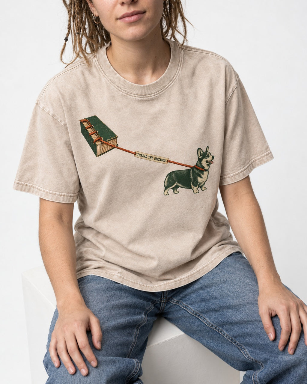 Thread the Distance with Corgi Washed Tee in Apricot, worn by a seated model