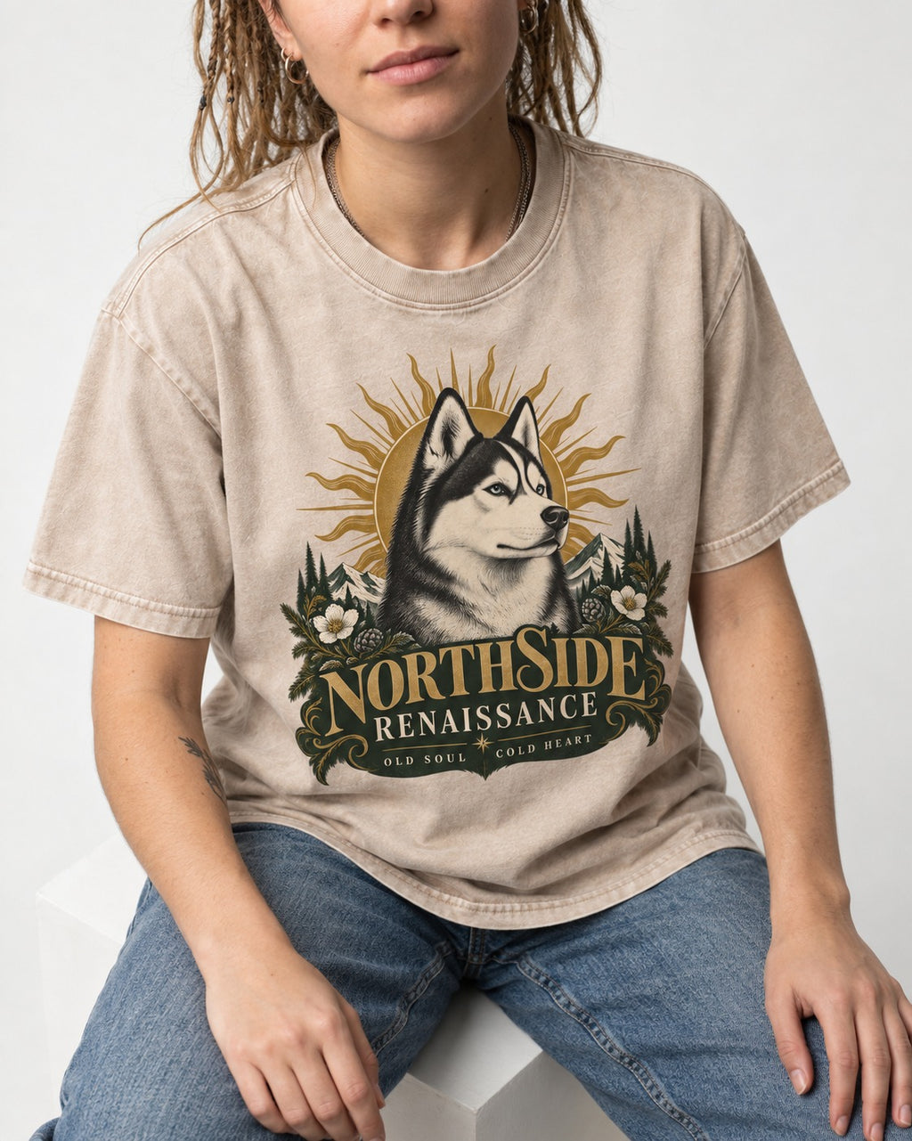 Northside Renaissance Husky Washed Tee in Apricot, worn by a seated model