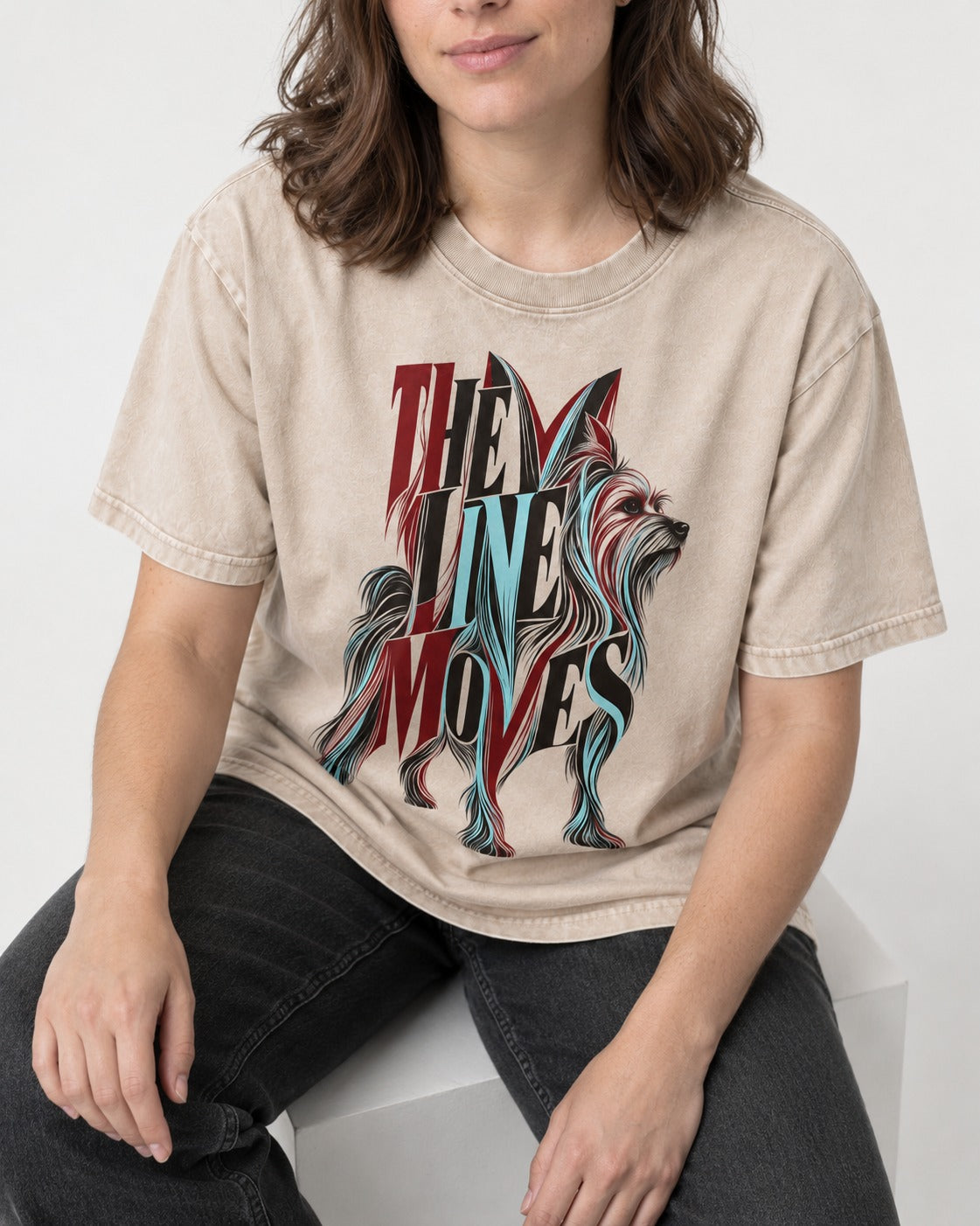 The One Moves Yorkshire Terrier Washed Tee in Apricot, worn by a seated model