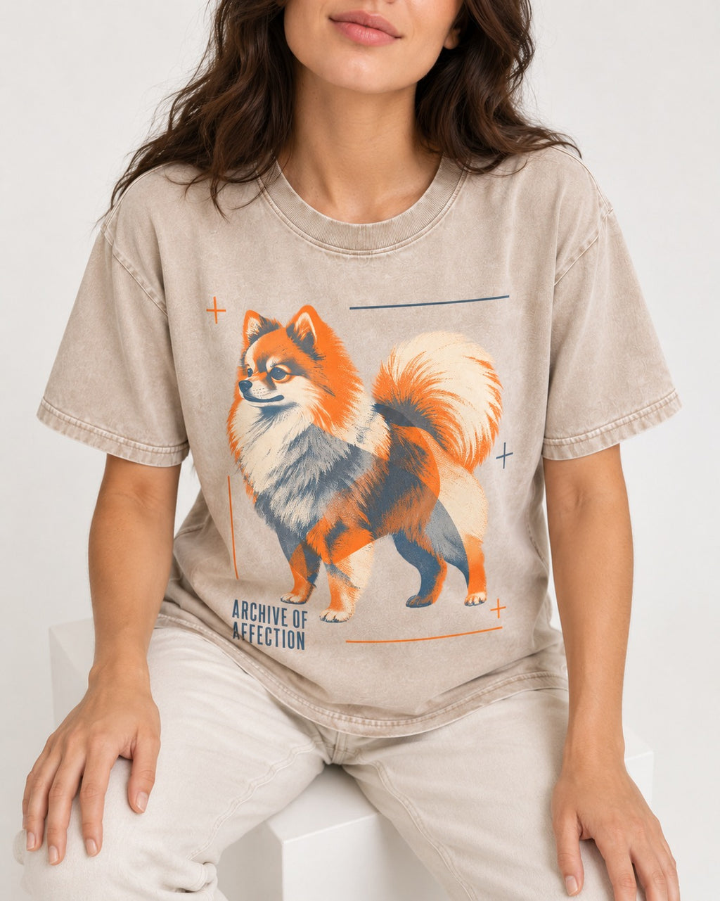 Pomeranian Archive of Affection Washed Tee in Apricot, worn by a seated model